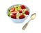 Bowl with prepared oatmeal, candied fruit and strawberry on white background