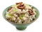 Bowl with prepared oatmeal, candied fruit and walnuts on white background