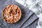 Bowl with quick breakfast of chocolate cornflakes with fresh milk on kitchen towel, spoon with flakes copy space