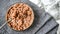 Bowl with quick breakfast of chocolate cornflakes with fresh milk on kitchen towel, spoon with flakes copy space