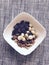 A bowl of raisins with macadamia nuts and pecans - NUTS & DRIED FRUIT