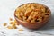 Bowl with raisins on wooden table. Dried fruit