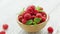 Bowl with raspberries and leaves