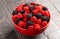 Bowl of Raspberry and Blackberry Gummy Candies on a Rustic Wooden Table
