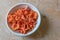 Bowl of red and orange cinnabar chanterelle mushrooms, organic food ingredient