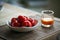 Bowl of red tomatoes and glass of carrot juice on the table