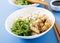 Bowl of rice, boiled white fish and wakame chuka or seaweed salad.