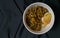 a bowl of rice meal with onsen egg and teriyaki beef on black background