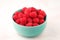 A bowl with ripe bright raspberries