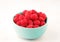 A bowl with ripe bright raspberries