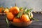 Bowl with ripe tangerines and blurred Christmas lights