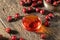 A bowl of rosehip seed oil with dried rosehips