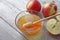 Bowl rustic honey and apples on wooden table. Traditional celebration food for the Jewish New Year. Concept Rosh Hashana