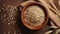 Bowl of rye grains and ears on wooden table, top view