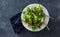 Bowl salad green mache leaves baked tomatoes top view