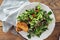 Bowl salad green mache leaves baked tomatoes on wooden table