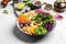 Bowl salad with halloumi cheese, avocado, cucumber, chickpeas, watermelon radish, potato purple sweet. Buddha bowl, healthy and