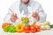 Bowl of salad vegetables and cook hand with spoon