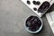 Bowl and scoop of sweet dried plums on table, top view with space for text.