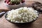 Bowl of sliced organic white onions on Wooden background