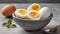 Bowl with soft boiled eggs on gray table