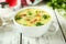 Bowl of soup on a white wooden background