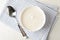 Bowl of sour cream yogurt, spoon and towel