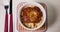 Bowl of spaghetti pasta in Bolognese sauce placed on the table.