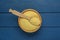 Bowl and spoon with raw couscous on blue wooden table, top view