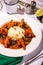 Bowl of steaming, freshly cooked rice accompanied by shrimp in tomato sauce