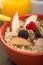 Bowl of steel cut oats served with fresh fruit and honey