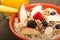 Bowl of steel cut oats served with fresh fruit and honey