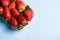 Bowl of strawberries on blue background