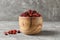 Bowl with sweet cranberries on table. Dried fruit