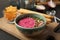 Bowl with tasty beet hummus, bread sticks