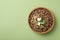 Bowl of tasty buckwheat on green background