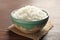 Bowl of tasty cooked white rice on wooden table