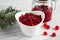 Bowl of tasty cranberry sauce on table