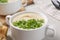 Bowl with tasty creamy soup of parsnip on light grey table, closeup