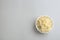 Bowl of tasty mashed potato on light background, top view