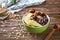 Bowl with tasty oatmeal, fruits and spices on wooden background