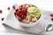 Bowl with tasty oatmeal, kiwi and berries on napkin