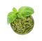 Bowl of tasty pesto sauce with basil leaves isolated on white