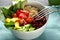 Bowl with tasty quinoa salad on table, closeup