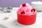 Bowl of tasty raspberry snow ice cream on board, closeup