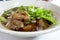 Bowl of thai style pork noodle soup