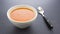 Bowl of tomato bisque soup with spoon