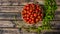 Bowl of tomatoes on grainy wooden boards