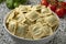 Bowl with traditional fresh Italian raviolini stuffed with Basilicum and Provolone