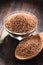 Bowl of uncooked spelt on wooden table